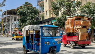 Tuk-tuk drivers transport residents' belongings amid fears of looting as residents and fighters leave the city in Mekelle on October 3, 2026. (Photo by AFP)