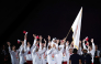 Members of the Qatar delegation celebrate as high jump legend Mutaz Barshim carries the OCA flag during the closing ceremony. (Xinhua)