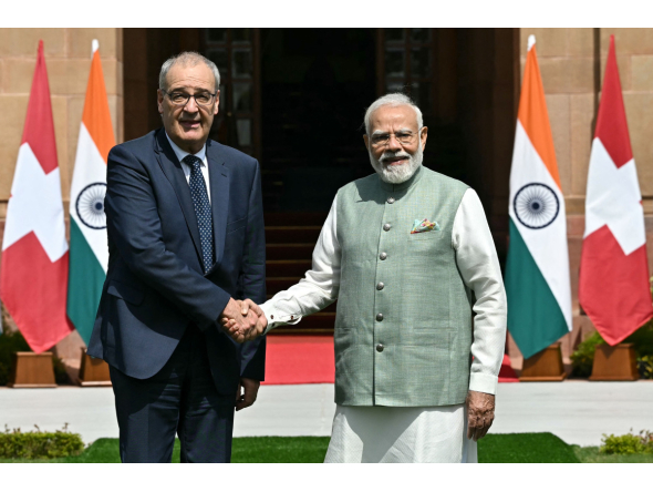 India's Prime Minister Narendra Modi (R) and Switzerland's President Guy Parmelin shake hands before their meeting at the Hyderabad House in New Delhi on October 5, 2026. (Photo by Sajjad HUSSAIN / AFP)