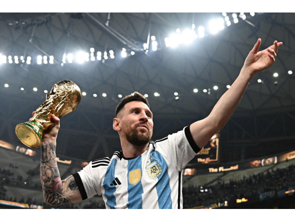 Argentina's captain and forward #10 Lionel Messi pose with the FIFA World Cup Trophy after Argentina won the Qatar 2022 World Cup final football match between Argentina and France at Lusail Stadium in Lusail, north of Doha on December 18, 2022. Photo by Anne-Christine POUJOULAT / AFP