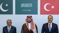 This handout photograph taken and released by the Turkish Foreign Ministry on October 5, 2026 shows (L-R) Pakistan's Deputy Prime Minister and Minister for Foreign Affairs Ishaq Dar, Saudi Defence Minister Prince Khalid bin Salman Al Saud and Turkish Foreign Minister Hakan Fidan posing during a meeting of the Strategic Political and Defense Committee, established under the Mecca Joint Defense Agreement, in Riyadh. (Photo by Handout / Turkish Foreign Ministry / AFP)