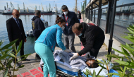 An injured crew member from a ship struck by drones in Bulgaria's exclusive economic zone is moved on a stretcher after he was rescued, at the Varna harbour on October 6, 2026.  (Photo by AFP)
 