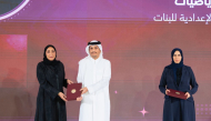 Prime Minister and Minister of Foreign Affairs H E Sheikh Mohammed bin Abdulrahman Al Thani and Minister of Education and Higher Education H E Lolwah bint Rashid Al Khater honouring a teacher during the ceremony yesterday.