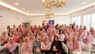 Participants and experts pose for a group photo at the awareness session. 