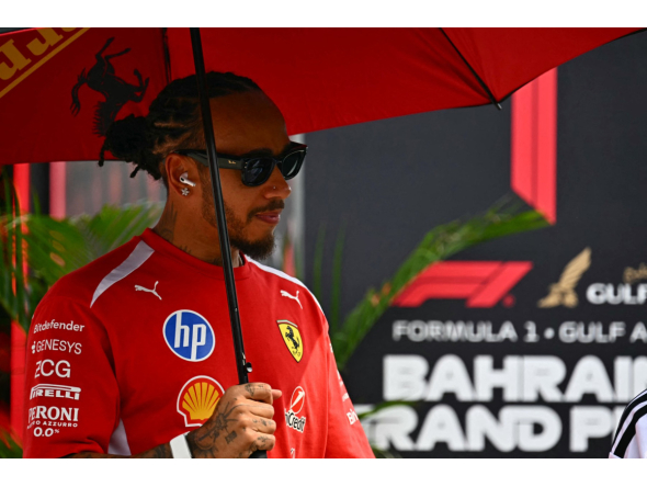 Ferrari's British driver Lewis Hamilton arrives ahead of the Formula One Bahrain Grand Prix in Sepang on October 4, 2026. (Photo by Lillian SUWANRUMPHA / AFP)
