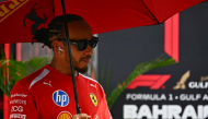 Ferrari's British driver Lewis Hamilton arrives ahead of the Formula One Bahrain Grand Prix in Sepang on October 4, 2026. (Photo by Lillian SUWANRUMPHA / AFP)
