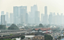 A dense layer of haze blankets the Kuala Lumpur skyline as a light rail train passes through the city on October 7, 2026.  (Photo by Arif Kartono / AFP)