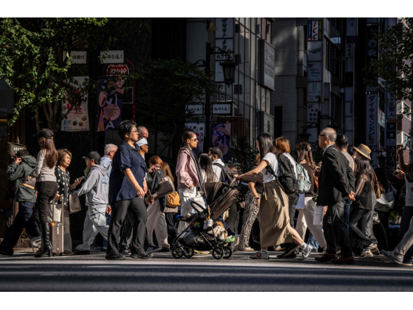 People cross a street in Ginza area of Tokyo on October 8, 2026. (Photo by Yuichi YAMAZAKI / AFP)