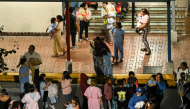 People carrying babies evacuate the Children's Hospital after a magnitude 6.0 aftershock is felt following a magnitude 7.6 earthquake in Panama City, Panama, on October 9, 2026. (Photo by Martin Bernetti / AFP)