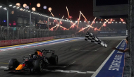 Red Bull Racing's Dutch driver Max Verstappen crosses the chequered flag at the finish line to win the Formula One Singapore Grand Prix at the Marina Bay Street Circuit in Singapore on October 11, 2026. (Photo by Ng Han Guan / POOL / AFP)