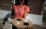 Alice Cerutti, owner of Cascina Oschiena, holds a tray displaying four different types of rice at the farm in the countryside of Crova, near Vercelli, northwestern Italy on September 28, 2026. Photo by Marco Bertorello / AFP