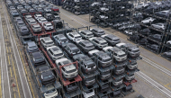 Chinese-made cars are seen in specialised vehicle racks in preparation for loading onto ships for export at the Taicang Port area of Suzhou Port on October 12, 2026. (Photo by CN-STR / AFP) 