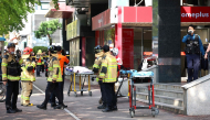 Police officers and firefighters arrive at the scene after a stabbing incident at a supermarket in Incheon on October 13, 2026. (Photo by YONHAP / AFP) 