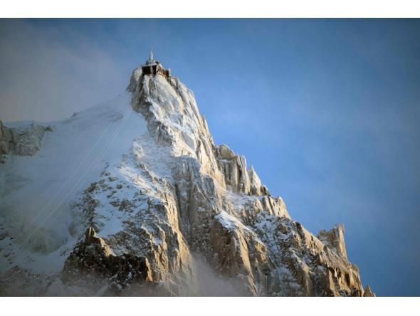 (Files) This photograph shows L'aiguille du Midi of the Massif du Mont-Blanc mountain range in the French Alps in France, on February 11, 2026. (Photo by Olivier Chassignole / AFP)