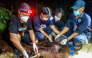 Natural Resources Conservation Agency (BKSDA) and Orangutan Foundation International (OFI) officials examine an orangutan after it was evacuated from a forest and land fire in the Baamang area of East Kotawaringin, Central Kalimantan on October 14, 2026. (Photo by REINA / AFP)
