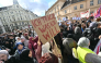 (Files) A protester holds a placard reading 
