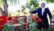 The 117-year-old Qamile Marra poses during an interview with AFP in the garden of her home in the village of Ferras, on October 3, 2026.(Photo by Adnan Beci / AFP)
 