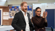 Britain's Prince Harry, Duke of Sussex and his wife Meghan, Duchess of Sussex, react during a visit to Epic Partners in Nottingham, central England on October 15, 2026. Photo by Joe Giddens / POOL / AFP