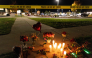 Candles and flowers are seen at a makeshift memorial outside the Silver Rail Elementary School following a shooting in Bend, Oregon, on October 15, 2026. Photo by Payton Bruni / AFP