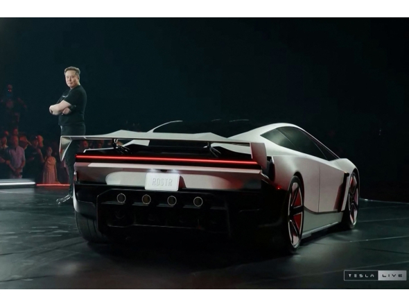 A grab taken on October 16, 2026 from a live feed released by Tesla shows Tech billionaire Elon Musk unveiling on October 15 the next-generation Roadster electric car in McGregor, Texas, United States. (Photo by Tesla / AFP)