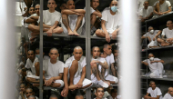 Inmates are pictured during a visit of Costa Rica's President Laura Fernandez at the CECOT prison in Tecoluca, El Salvador on October 16, 2026. (Photo by Marvin RECINOS / AFP)