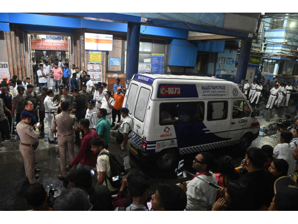 An ambulance carrying Durga Puja Pandal stampede victims stops in front of the emergency building of Calcutta Medical College and Hospitalas relatives of Durga Puja Pandal stampede victims mourn in Kolkata on October 16, 2026. (Photo by AFP)