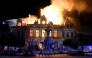 This photograph shows a fire burning and destroying the city hall after a group of individuals forced entry into the building in Limoges, central France on October 17, 2026. (Photo by Pascal Lachenaud / AFP)