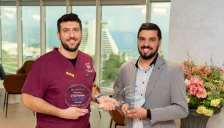 Dr. Yaser Hamdoun (left) receiving the awards. 