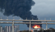 Smoke rises above the city following an air attack on the oil terminal in Saint Petersburg on October 18, 2026, amid the ongoing Russian-Ukrainian conflict. (Photo by AFP)
