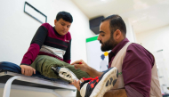 Mahmoud Abou Nusair has his prosthetic attached at a medical centre in Amman on October 13, 2026 as part of the 