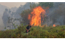 A firefighter extinguishing a fire at Sungai Tabuk village in Indonesia's Kalimantan Province on October 16 © MUDA SAGALA / AFP
