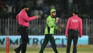 Pakistan's Arafat Minhas (C) celebrates after taking his sixth wicket to dismiss England's Adil Rashid as umpires Pakistan's Faisal Afridi (L) and Bangladesh's Sharfuddoula react during the one-day international (ODI) tri-series cricket match between Pakistan and England at the Rawalpindi Cricket Stadium in Rawalpindi on October 20, 2026. (Photo by Aamir QURESHI / AFP)