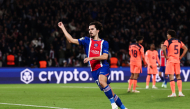 PSG's Portuguese midfielder #17 Vitinha celebrates after scoring his team third goal during the UEFA Champions League first round day 3 football match between Paris Saint-Germain (PSG) and FC Barcelona at the Parc de Princes stadium in Paris on October 20, 2026. (Photo by FRANCK FIFE / AFP)