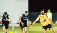 Al Sadd's Paulo Otavio Pedro Miguel and Hassan Al Haydos during a training session. 