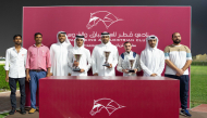 The connections of Keheilah Al Sakab pose with their trophies. Deputy Director of the QREC Registration and Studbook Department Saad Ali 
Al Kubaisi presented the Asherij Cup. PICS: Juhaim/QREC