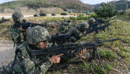 This handout photo taken on October 21, 2026 and provided by the Republic of Korea's Defence Ministry on October 22, 2026 shows South Korean Marines taking part in a comprehensive island defence exercise on Baengnyeong island near the maritime border with North Korea. (Photo by Handout / South Korean Defence Ministry / AFP) 