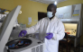 (FILES) A health official works in the laboratory extraction room of the Institute of Lassa Fever Research and Control in Irrua Specialist Teaching Hospital in Irrua, Edo State, midwest Nigeria, on March 6, 2018. (Photo by PIUS UTOMI EKPEI / AFP)
