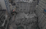 This aerial view shows personell from the Kenya Defence Forces Disaster Response Battalion inspecting the rubble of a collapsed residential building that was still under construction in the Eastleigh neighborhood of Nairobi on October 23,2026. Photo by Tony Karumba / AFP