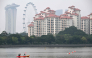 People row a canoe along the Kallang river as the haze eases in Singapore on October 23, 2026. (Photo by Roslan RAHMAN / AFP)
