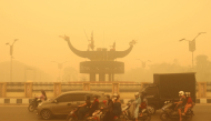 Motorcyclists wearing a face mask ride amid thick haze from forest and land fires in the region in Palangkaraya, Central Kalimantan, on October 24, 2026. (Photo by REINA / AFP)