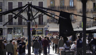 People walk past a burnt sunshade on a terrace damaged during overnight riots in Catalunya square in Barcelona, on October 25, 2026. (Photo by Manaure Quintero / AFP)
 
