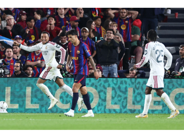 Real Madrid's French forward #10 Kylian Mbappe (L) celebrates scoring his team's first goal during the Spanish league football match between FC Barcelona and Real Madrid CF at Camp Nou Stadium in Barcelona on October 25, 2026. (Photo by Josep LAGO / AFP)
