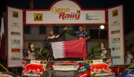 Qatar's Nasser Al-Attiyah and his Spanish navigator Candido Carrera celebrate their victory.  