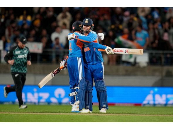 India's Abhishek Sharma (L) hugs teammate Vaibhav Sooryavanshi during the 3rd T20 cricket match between New Zealand and India. (Photo by Marty Melville / AFP)