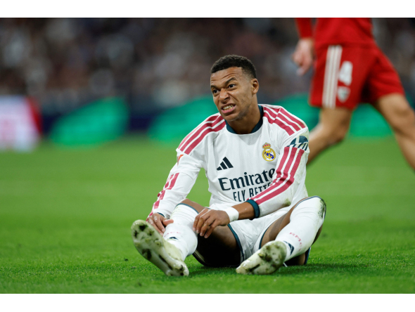 Real Madrid's French forward #10 Kylian Mbappe reacts on the ground during the Spanish league football match between Real Madrid CF and Sevilla FC at the Santiago Bernabeu stadium in Madrid on October 18, 2026.(Photo by Oscar DEL POZO / AFP)