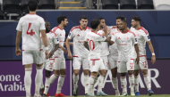Al Shamal players celebrate a goal against Al Hilal.