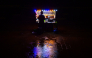 A vendor selling prawns waits for customers at the Galle Face seafront promenade, during a rainy night in Colombo on October 26, 2026. (Photo by Ishara S. KODIKARA / AFP)