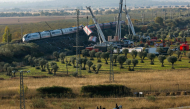 Spanish mounted police survey the perimeter around the damaged carriages of a train crash, a day after the accident on October 29, 2026. (Photo by Oscar Del Pozo / AFP)