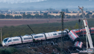 Investigators survey debris amongst the damaged carriages of a train crash between two high-speed units, a Renfe AVE train and an Iryo train around 150 km south of Madrid between Urda and Los Yebenes in the province of Toledo, a day after the accident on October 29, 2026. Photo by OSCAR DEL POZO / AFP