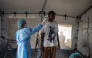 A health worker takes the temperature of a traveller after arriving in Bimbo district south-west of Bangui, on October 28, 2026. (Photo by AFP)